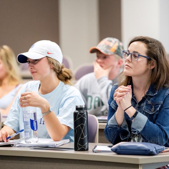 Students smile during a lecture