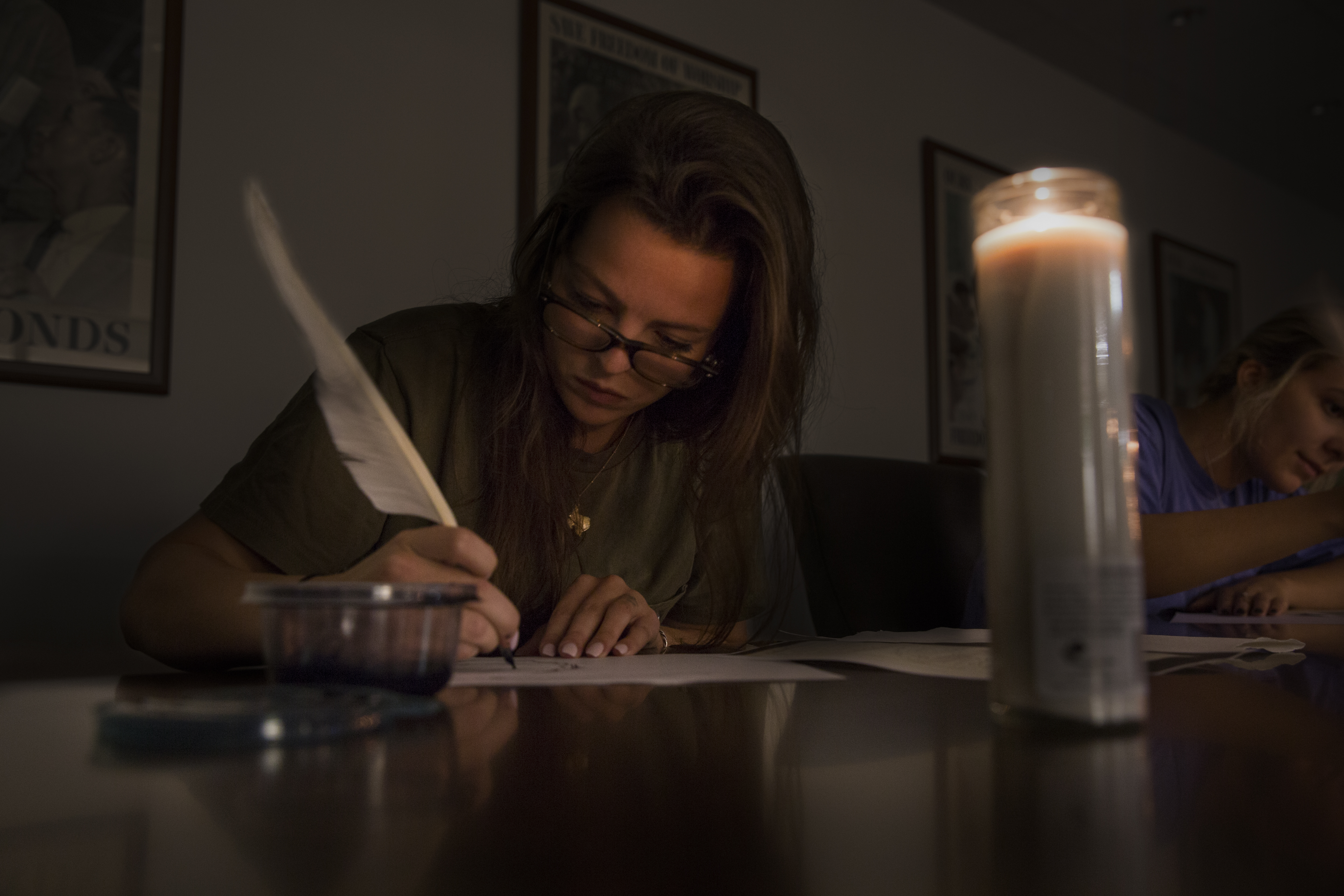 A student writes with a quill