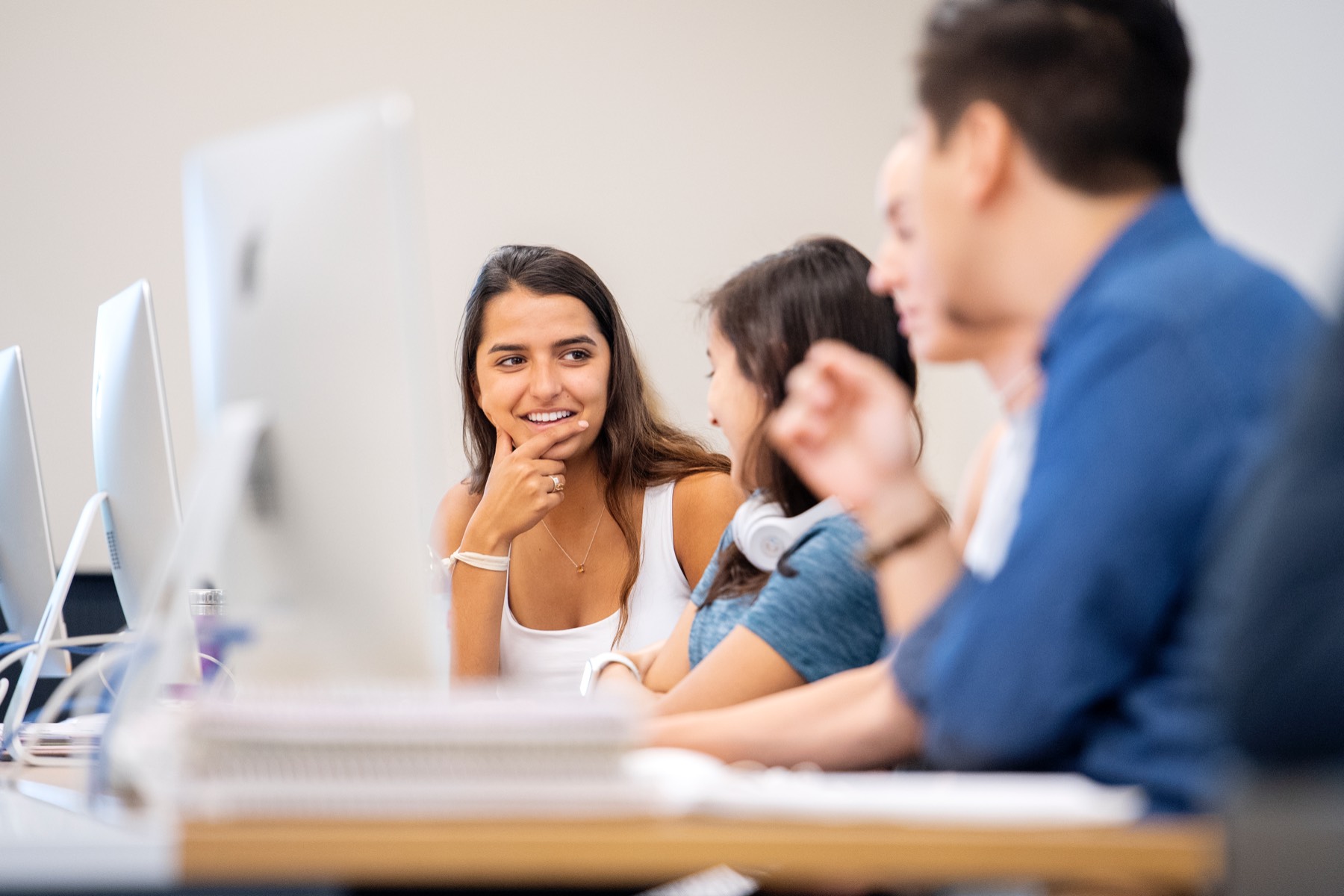 Students talk in a computer lab 