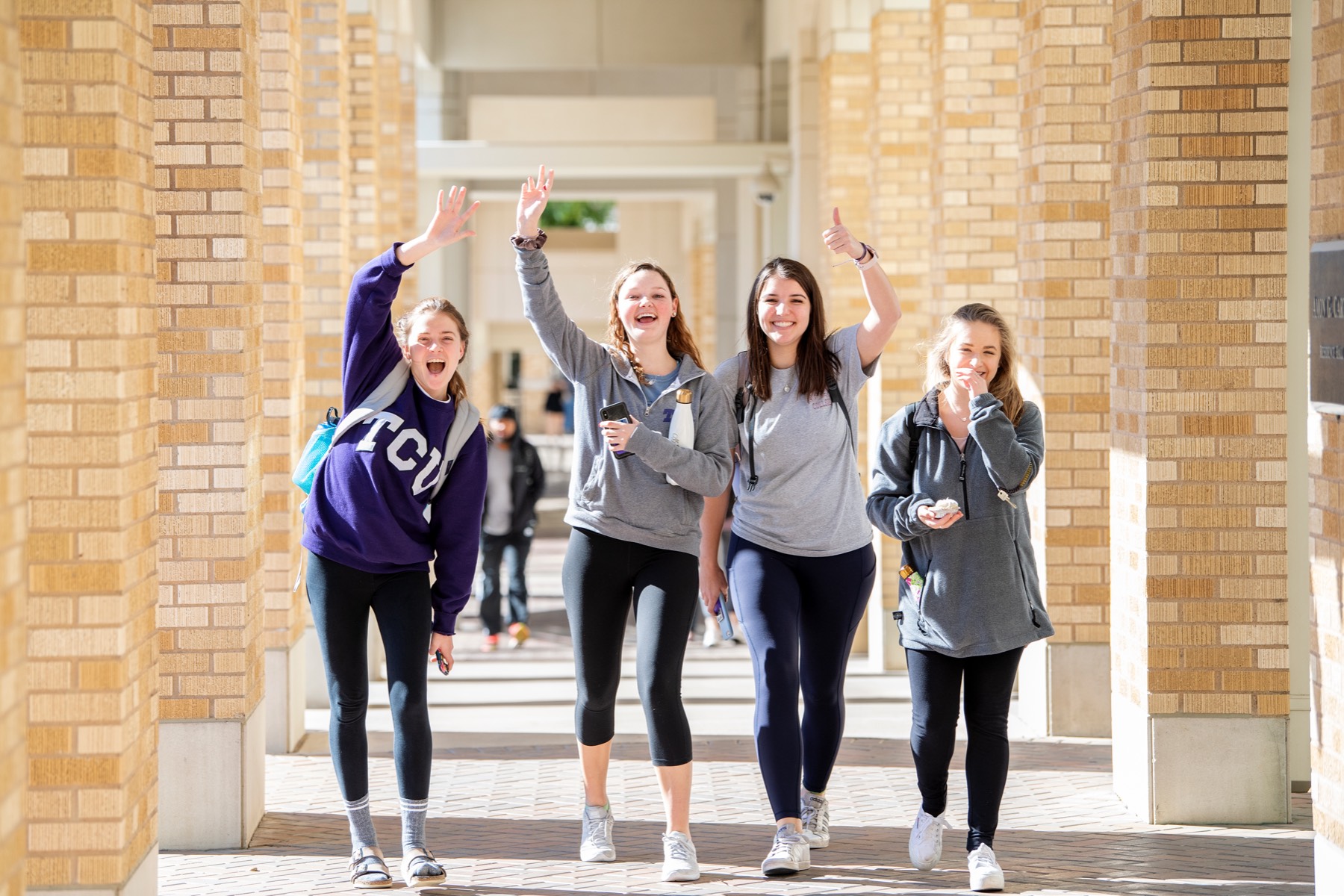 Students wave at the camera