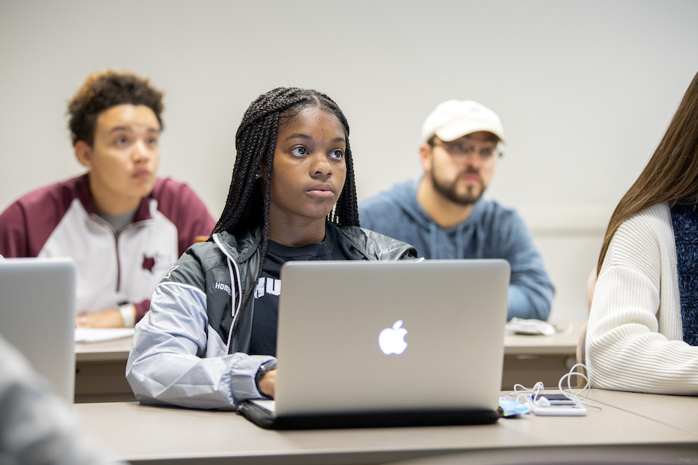 A student works on her laptop during class