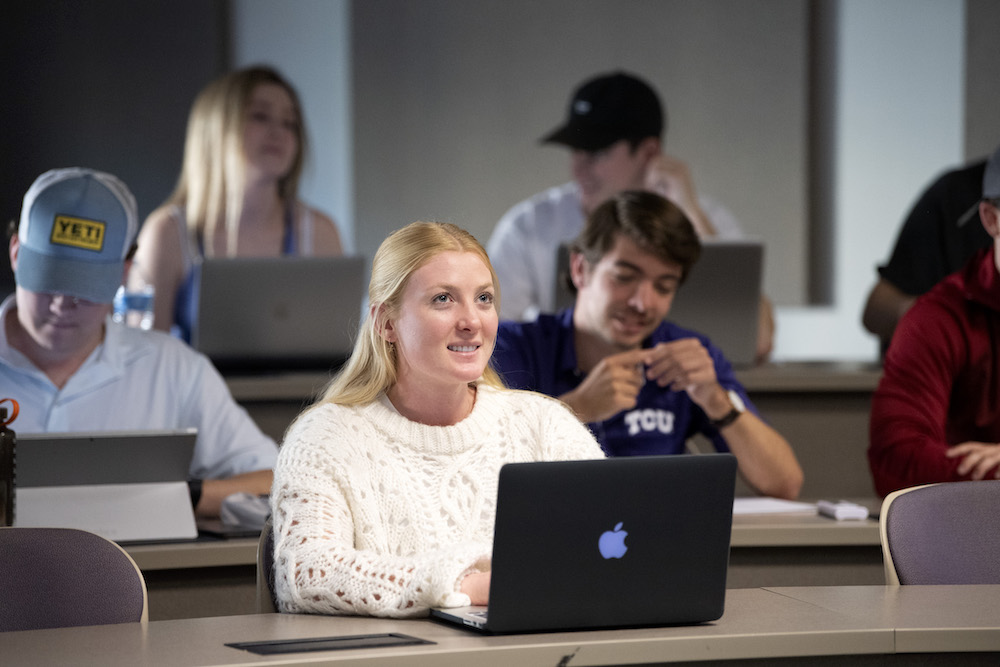 A student smiles in class