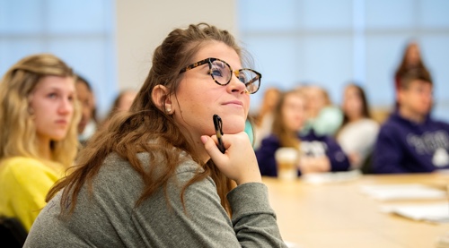 Student listens to professor in lecture