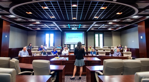 Student presenting in a debate-style chamber