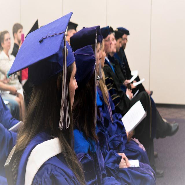 Students and professors seated at hooding ceremony