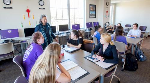 Student presenting in a debate-style chamber