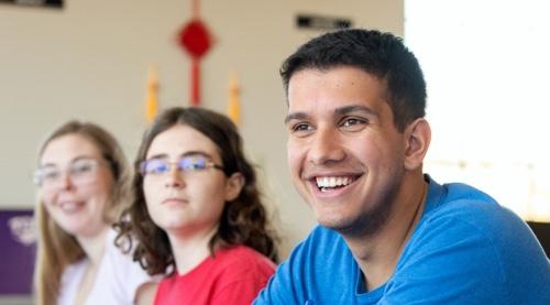 male student with other students in background