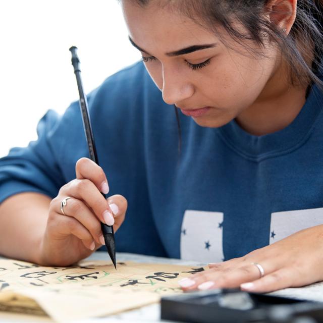 A student practices Chinese calligraphy 