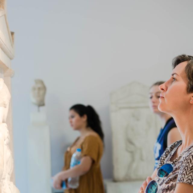 Students look at an artifact in a museum